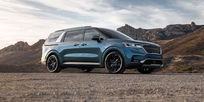 2024 Kia Carnival on dirt from the side