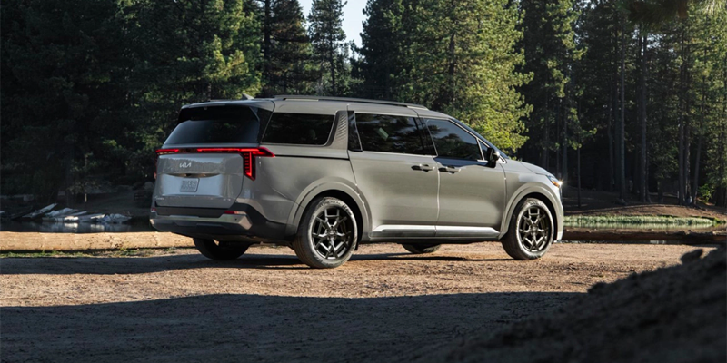 2025 Kia Carnival Hybrid in the woods