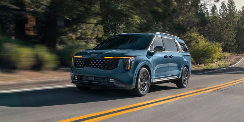 2025 Kia Carnival Hybrid driving on the road